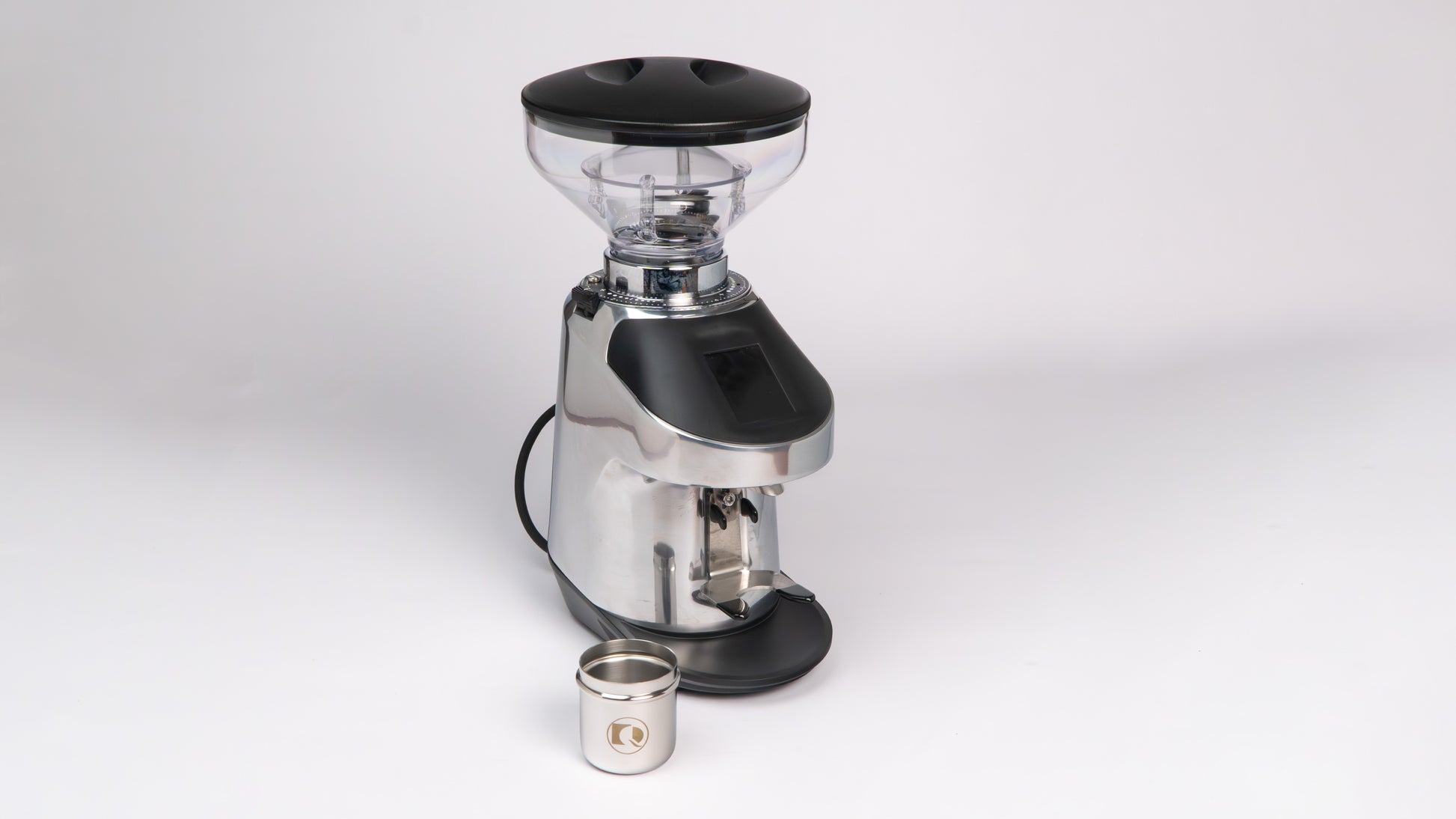 Quamar Nemo QE Black Coffee Grinder displayed with a metal container for ground coffee.