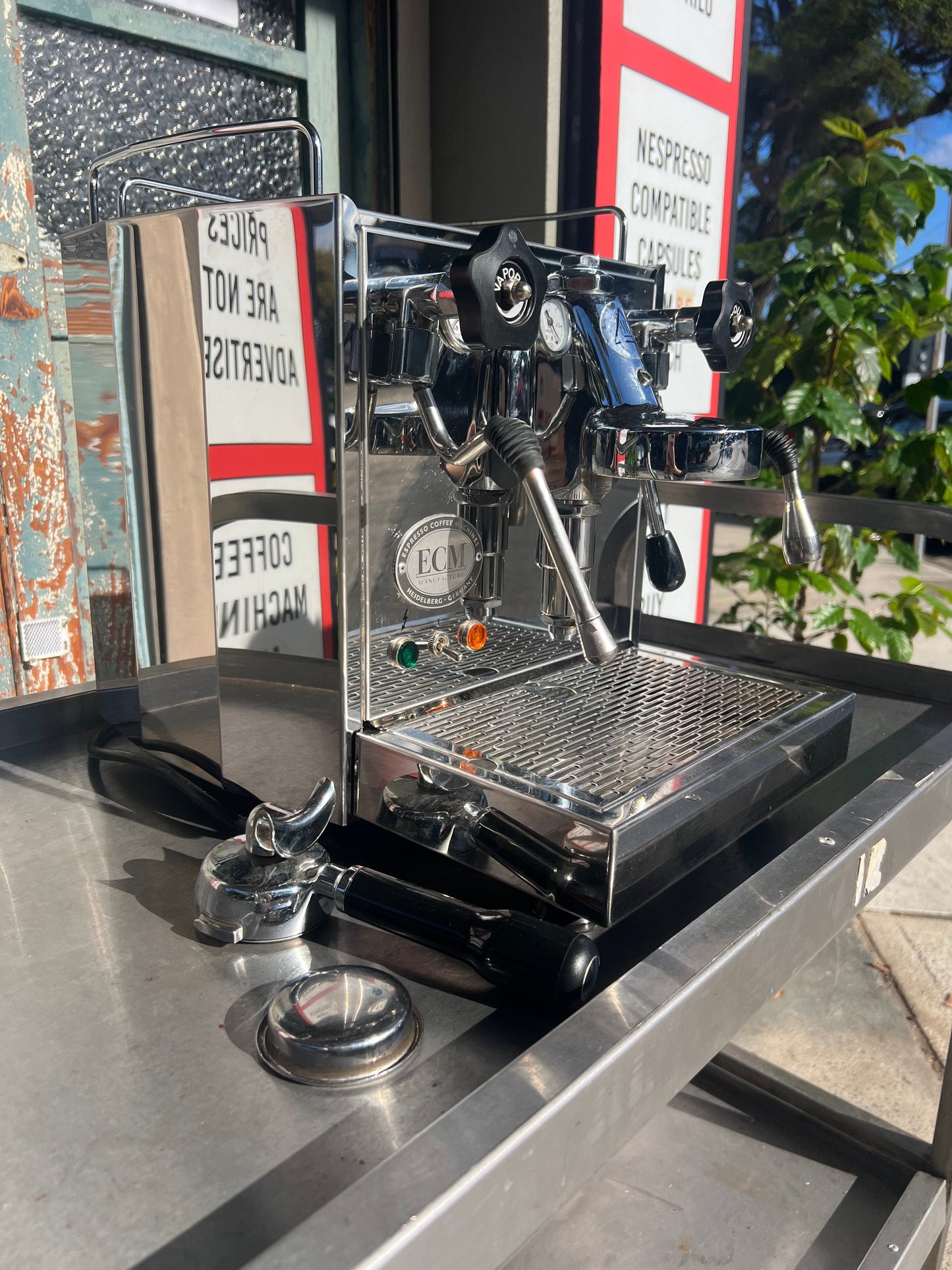 ECM Barista Coffee Machine displayed on a table with sunlight reflecting off its polished surface.