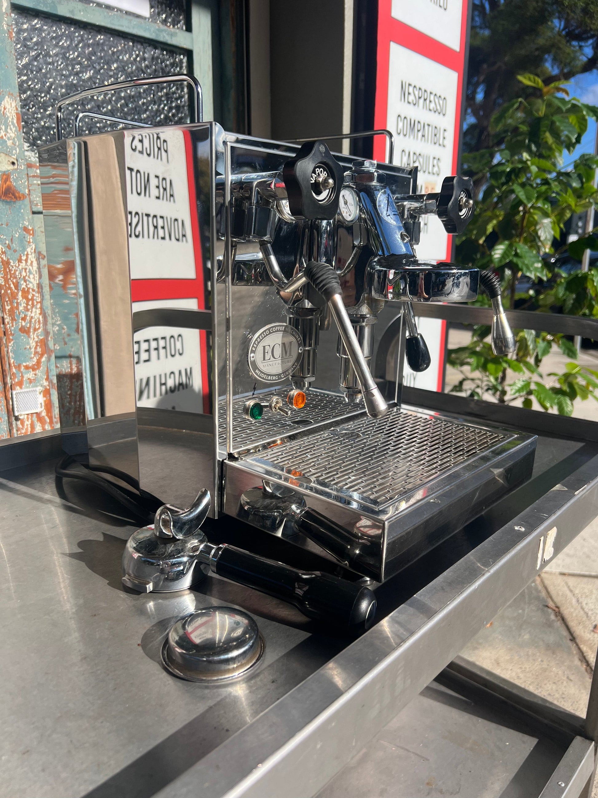 ECM Barista Coffee Machine displayed on a table with sunlight reflecting off its polished surface.