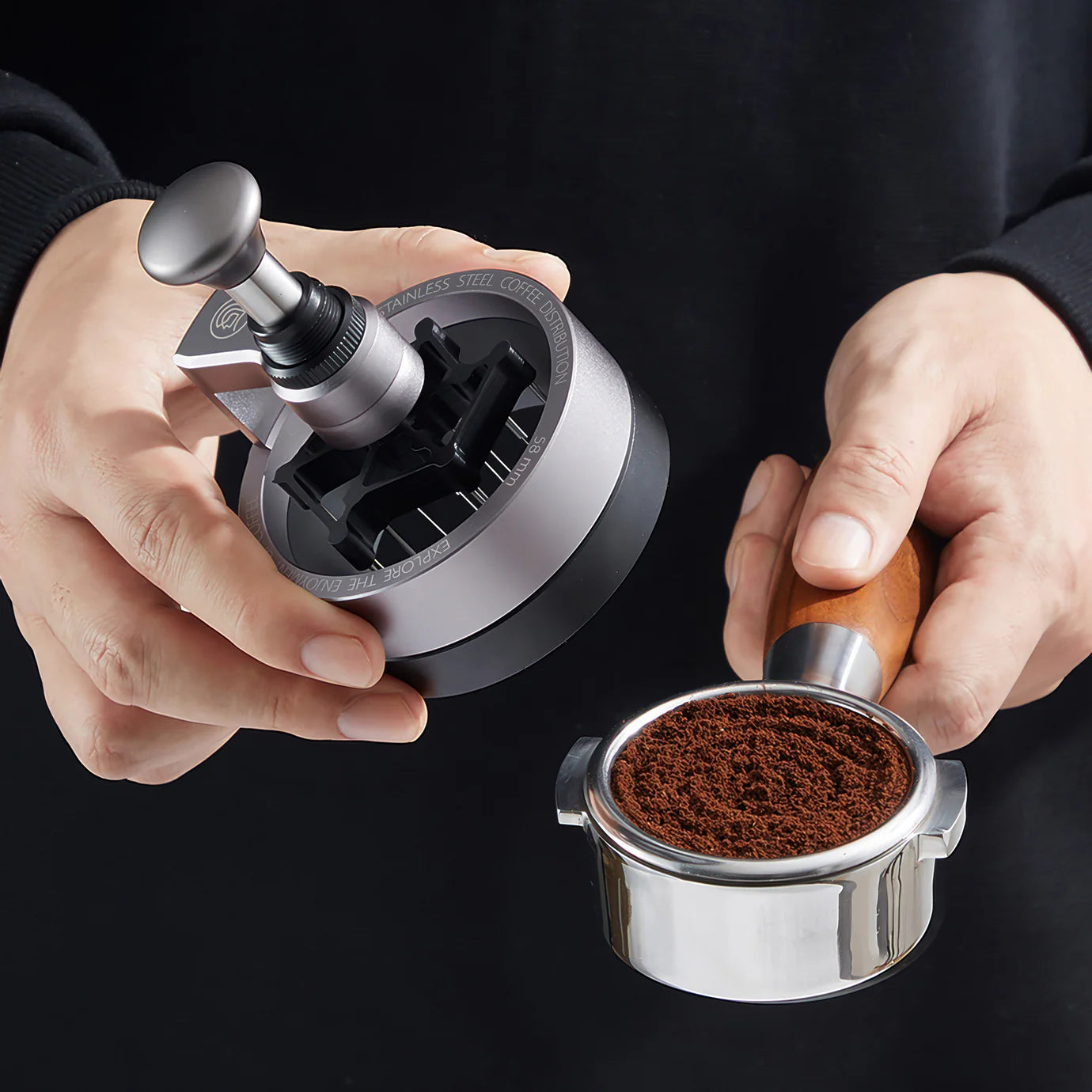 ZeroHero 58mm Sword Needle Distributor in hands, showcasing precision coffee ground distribution tool.